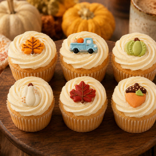 Fall cupcake toppers styled on frosted cupcakes with autumn decor