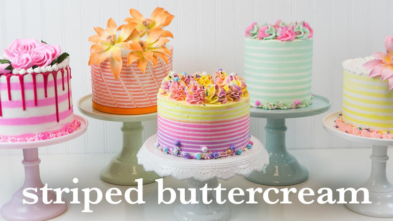Striped buttercream cake with colored stripes revealed by bench scraper