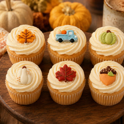 Fall cupcake toppers styled on frosted cupcakes with autumn decor